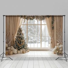 a christmas tree in front of a window with curtains and presents on the windowsill