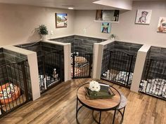 a room filled with caged animals and flowers on top of a wooden table in front of them