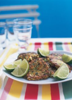 some food is on a plate with limes and water in the backgroud