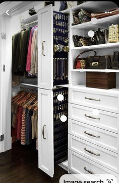 an organized closet with white cabinets and drawers