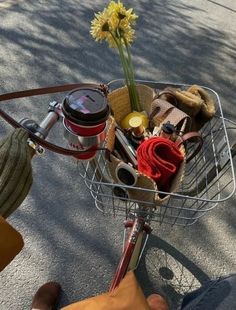 a basket full of items sitting on the back of a bike