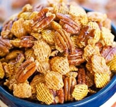 a blue bowl filled with pecans on top of a wooden table