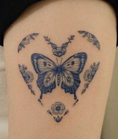 a woman's thigh with a butterfly tattoo on it