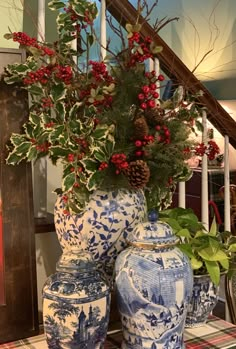 three blue and white vases sitting on top of a table