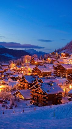 a snowy mountain town lit up at night