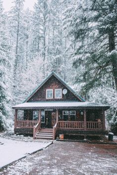 a cabin in the woods with snow on the ground