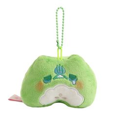 a green stuffed animal with a chain hanging from it's back and eyes closed