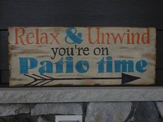 a wooden sign that says relax and unwind you're on panic time with an arrow