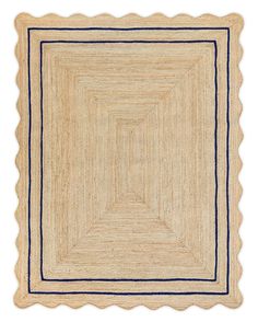 an area rug with scalloped edges in beige and navy blue on a white background