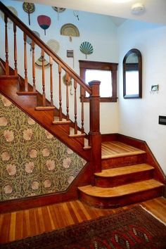 the stairs are made of wood and have decorative wallpaper on them