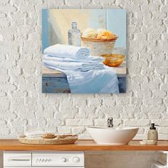 a painting on the wall above a washer and dryer in a room with white walls