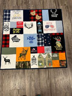 there is a quilt on the floor that has many different patches and animals all over it