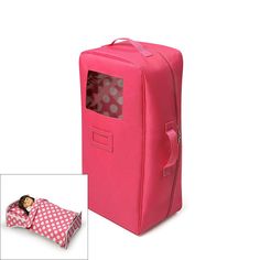 a pink suitcase with polka dots on it and a doll in the bag next to it