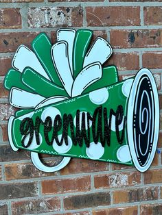 a green and white sign on a brick wall that says,'green wave '