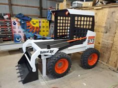 a white and black snow plow sitting in a garage