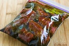 a bag filled with meat sitting on top of a wooden table