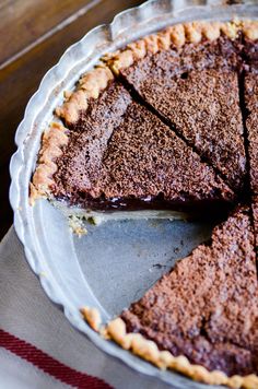 a chocolate pie with one slice missing from it