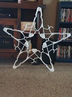 a white star sculpture sitting on top of a carpeted floor