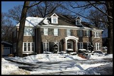 a large brick house with snow on the ground