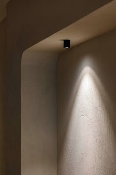 the light is shining on the wall in the room that has no one inside it