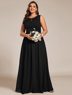 a woman in a long black dress holding flowers