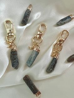 "✨ TRANQUILITY - CHAKRA ALIGNMENT  - COMMUNICATION ✨ Handmade Kyanite Point Raw Natural Gemstone Keychain with Gold Plated Clasp and Moon charm. Each item is handcrafted and will not be identical. These gemstones are 100% genuine which makes them unique in color and size and have natural imperfections.  Length: 2.5\" height Color: Blue Gray some charcoal  NOTE: This listing is for (1) one keychain. ✨✨ HEALING PROPERTIES ✨✨ Kyanite aligns all chakras and dispels blockages. It brings balance and h Gemstone Keychain, Gold Keychain, Chakra Alignment, Crystal Keychain, Moon Charm, Psychic Abilities, Cute Packaging, Gemstone Healing, Green Aventurine