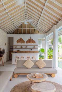 a living room filled with furniture next to a pool