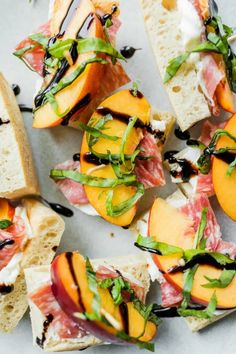 sliced peaches and prosciutto sandwiches with balsami on them are ready to be eaten