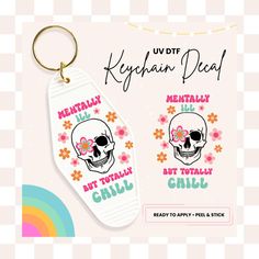 a keychain with a skull and flowers on it that says kryphan dead, but totally chillu