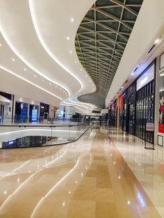 an empty shopping mall with lights on the ceiling