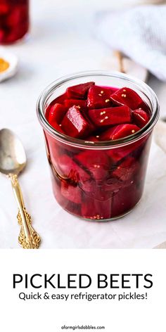 pickled beets in a glass jar with spoons