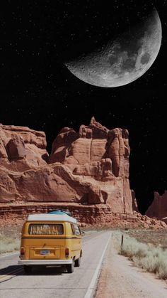 a yellow van is driving down the road in front of some rocks and a half moon