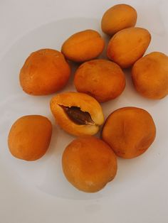 a white plate topped with oranges on top of a table