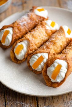 some food is on a white plate and ready to be eaten with orange slices in the middle