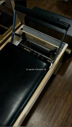 a black leather chair sitting on top of a wooden floor