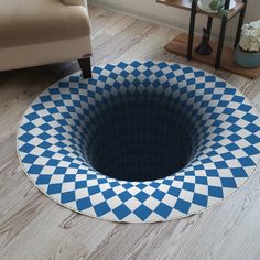 a blue and white checkerboard design rug in the middle of a living room