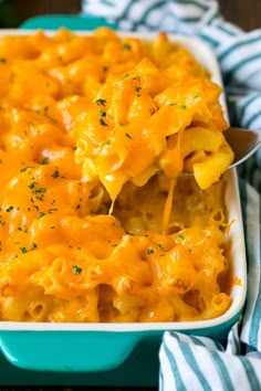 a blue dish filled with macaroni and cheese