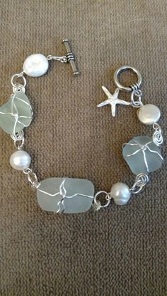 a silver bracelet with sea glass and pearls