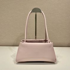 SHOP MORE LUXURY PRODUCTS HERE Description Prada Small Bag Pink For Women, Women’s Bags 9.8in/25cm A study of the lines characterizes this smallÃƒÂ¯Ã‚Â¿Ã‚Â½ÃƒÂ¯Ã‚Â¿Ã‚Â½ÃƒÂ¯Ã‚Â¿Ã‚Â½ÃƒÂ¯Ã‚Â¿Ã‚Â½ handbag. It stands out for its absolutely elegant silhouette emphasized by the long, narrow handle. This three-pocket accessory is decorated with the metal lettering logo. Size: 25 x 13.5 x 13 cm /9.8 x 5.3 x 5 inches (Length x Width x Height) PinkHandlesMetal hardwarePrinted lettering logo on the fr Classic Baguette Bag With Dust Bag For Daily Use, Classic Baguette Shoulder Bag For Shopping, Classic Square Baguette Bag For Shopping, Pink Shoulder Bag For Office, Pink Square Shoulder Bag With Dust Bag, Classic Pink Rectangular Bag, Daily Use Rectangular Baguette Bag, Pink Formal Bucket Shoulder Bag, Pink Formal Shoulder Bucket Bag