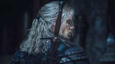 the witch with long white hair and black leather armor is staring at something in the distance