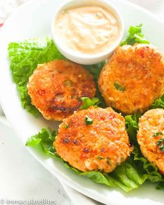 crab cakes on lettuce with dipping sauce