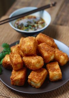 fried food on a plate with chopsticks next to it