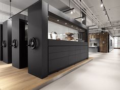 an open kitchen with black cabinets and stainless steel appliances