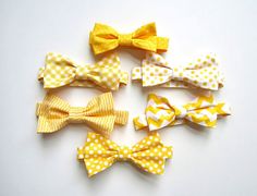 six yellow and white bow ties laid out on top of each other