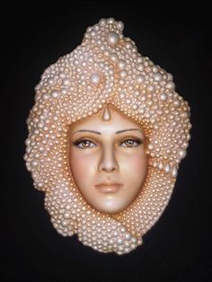 a woman's head with pearls on it