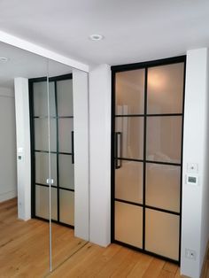 an empty room with glass doors and wood floors