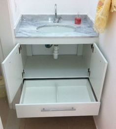 a white sink sitting under a mirror in a bathroom