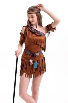 a woman in a costume holding a cane and posing for the camera with her hand on her hip