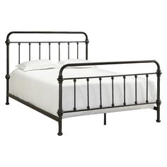 a metal bed frame with white sheets and pillows on it's headboard, against a white background