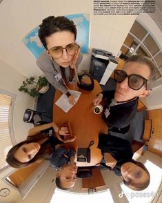 a group of people sitting around a wooden table